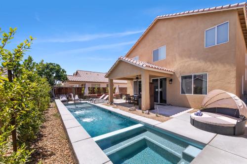 a home with a swimming pool and a house at Spacious Private Home with Saltwater Pool & Hot Tub in Coachella