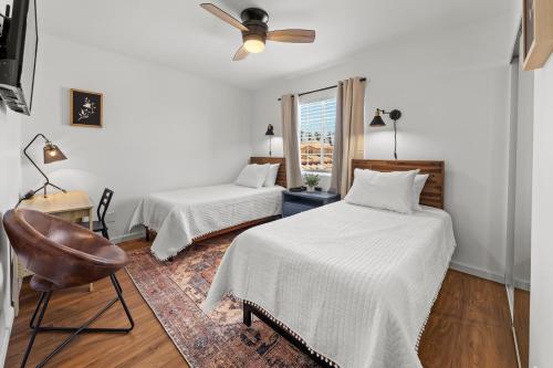 a bedroom with two beds and a ceiling fan at Spacious Private Home with Saltwater Pool & Hot Tub in Coachella
