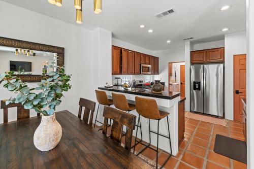 a kitchen and dining room with a table and chairs at Spacious Private Home with Saltwater Pool & Hot Tub in Coachella
