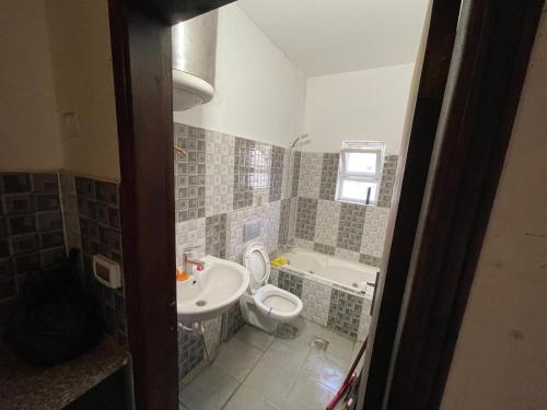 a bathroom with a toilet and a sink at stay baitlahem in Bayt Jālā