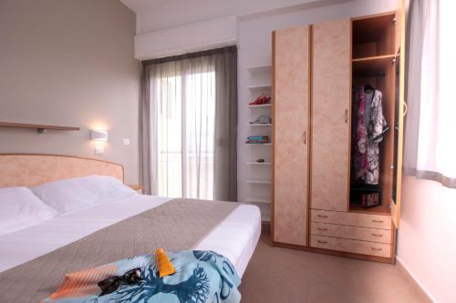 a bedroom with a large bed and a closet at Hotel Holland in Rimini