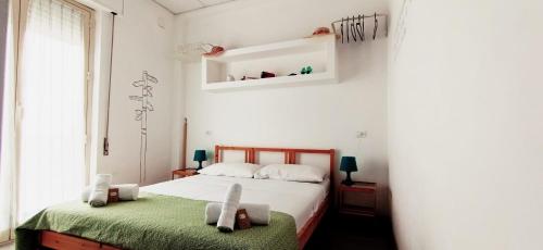 a bedroom with a bed with two stuffed animals on it at U'Cuntu affittacamere in Favignana