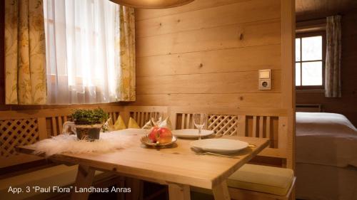 a wooden table with a bowl of fruit on it at Landhaus & Schloss Anras in Anras
