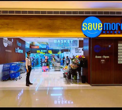 a man standing in front of a grocery store at Air Residences Condominium Deluxe in Manila