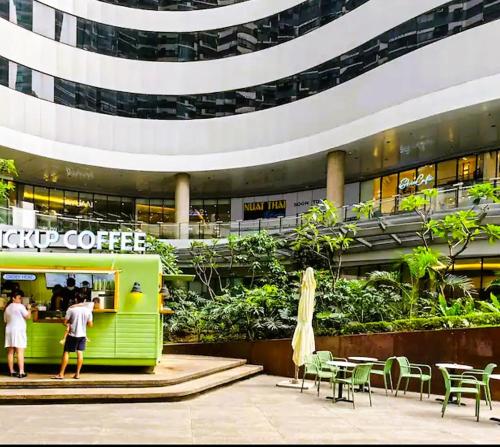 people standing in front of a coffee shop in a building at Air Residences Condominium Deluxe in Manila