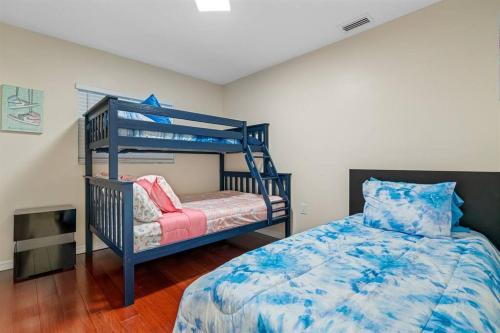 a bedroom with a blue bunk bed and a chair at Spacious & Amazing Home w/ Big Pool and Patio in Brandon