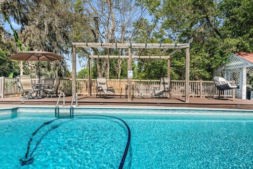 a swimming pool with an umbrella and chairs and a gazebo at Spacious & Amazing Home w/ Big Pool and Patio in Brandon