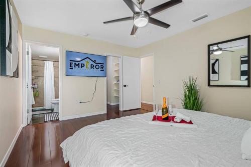 a bedroom with a white bed with a sign on it at Spacious & Amazing Home w/ Big Pool and Patio in Brandon