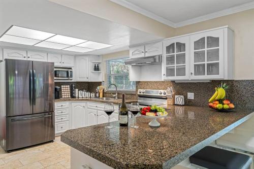 a kitchen with a counter with two glasses of wine at Spacious & Amazing Home w/ Big Pool and Patio in Brandon