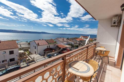 a balcony with a view of the ocean and buildings at Apartments Vita in Novi Vinodolski