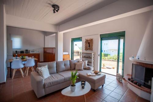 a living room with a couch and a table at Villa Calliope Lardos in Lardos