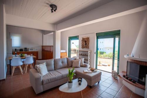 a living room with a couch and a table at Villa Calliope Lardos in Lartos