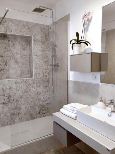 a bathroom with a shower and a sink and a tub at Domus terme romane in Cividale del Friuli