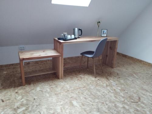a desk in a room with a chair and a table at MiddleHouse in Braşov