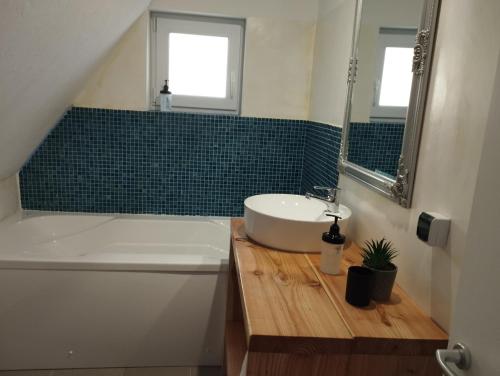 a bathroom with a sink and a toilet and a tub at MiddleHouse in Braşov