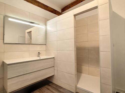 a bathroom with a sink and a mirror at Maison atypique - centre historique - Puy en Velay in Le Puy en Velay