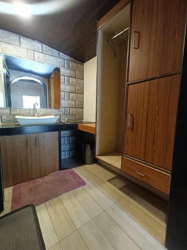 a bathroom with a sink and a mirror at Ellora Heritage Resort in Ellora