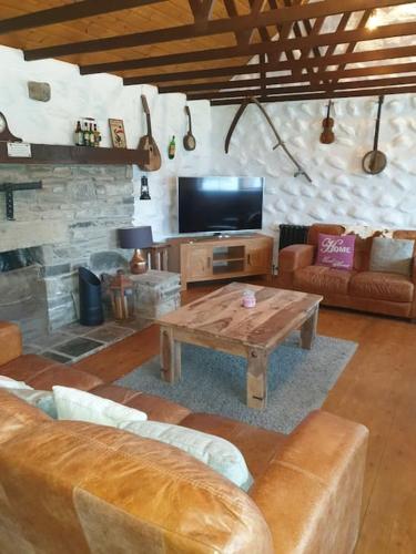 a living room with a couch and a coffee table at St Patrick's Cottage in Saul