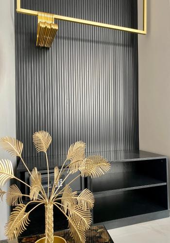 a plant in a vase next to a black wall at INTOMILAN Galleria Duomo I Boutique & Design Aparthotel in Milan