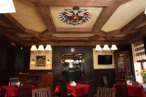 a dining room with tables and chairs and a ceiling at Fontush Boutique Hotel in Ivano-Frankivsʼk