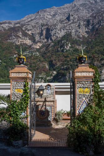 a gate to a house with a mountain in the background at Villa Palumbo in Positano