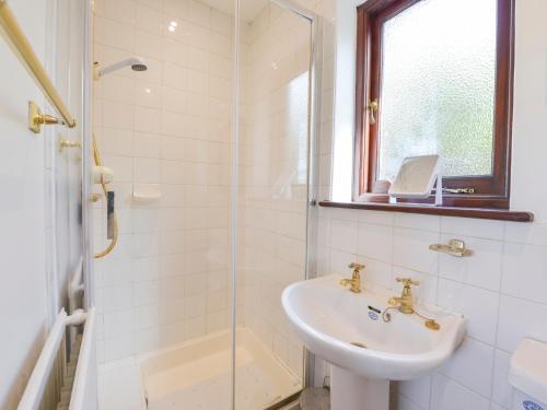 a bathroom with a sink and a glass shower at Little Barton in Stogumber