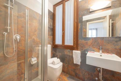 a bathroom with a toilet and a sink and a shower at Ca d'Oro Central Suite in Venice