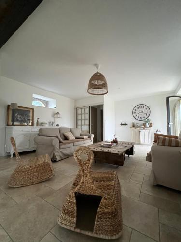 a living room with a couch and a table at Gîte Le Domaine Des Faluns in Le Quiou