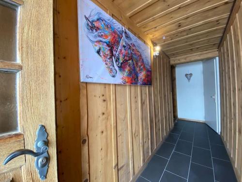 a room with a large painting on the wall at Wohnen mit Blick auf Eiger - ehemaliges Bauernhaus - 2 Schlafzimmer in Schwarzenburg
