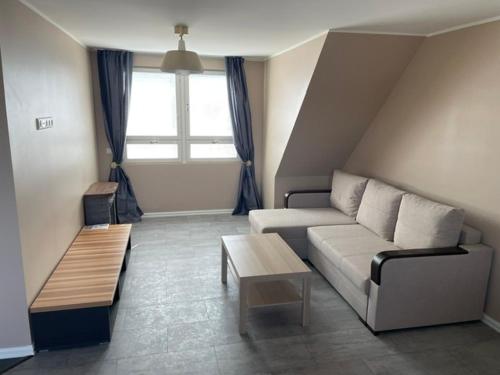 a living room with a couch and a table at Kassikäpa villa in Haapsalu