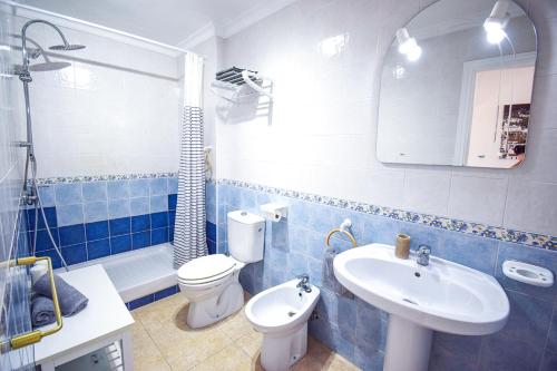 uma casa de banho azul e branca com um WC e um lavatório em Casa Clara, Frigiliana 2 Bedroom Apartment with communal pool HansOnHoliday Rentals em Frigiliana