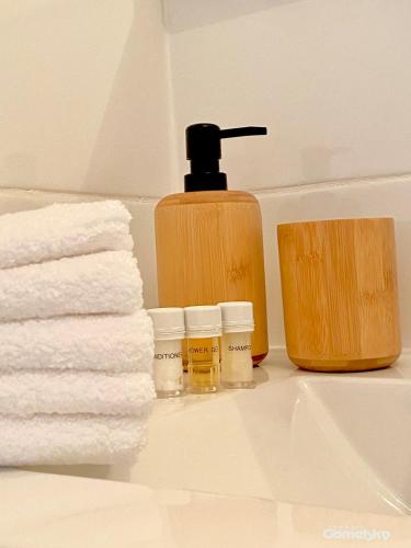 a bathroom sink with towels and a bottle of soap at • Spacious Apartment in Trendy Akko/Acre • in Acre