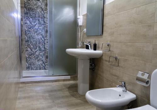 a bathroom with a sink and a toilet and a shower at PAPALi 289 in Catania