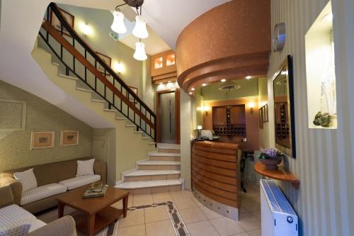 a living room with a staircase and a kitchen at Anesis in Kastoria