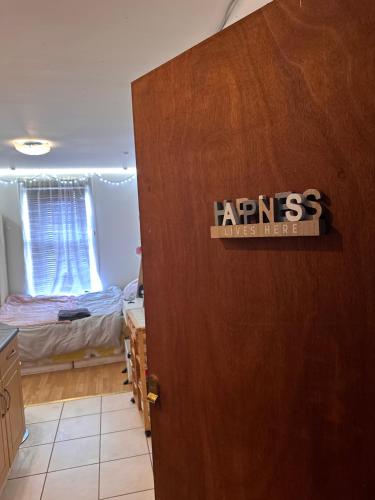 a door to a bedroom with a bed in a room at Studio flat in Stratford in London