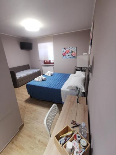 a small room with a bed and a table with a table sidx sidx at LucyBen GuestHouse in Cascia