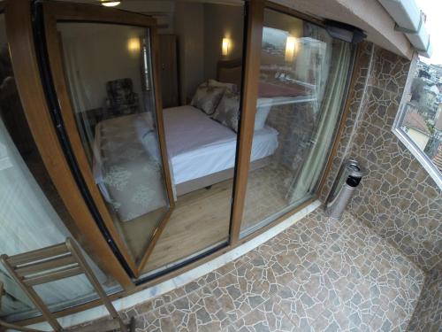 a small room with a mirror and a bed at Meydan Suites in Istanbul