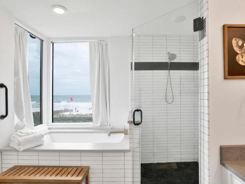 a white bathroom with a shower and a window at Beach Colony Towers #2B - Villa Monarch in Perdido Key