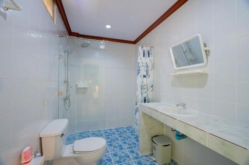 a bathroom with a toilet and a shower and a sink at Lemon House in Patong Beach