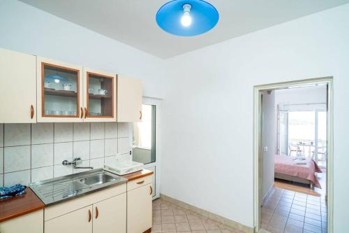 a kitchen with a sink and a room at Lovely studio apartment in Sobra