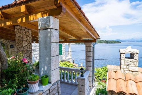 a stone house with a view of the water at By the sea in Sobra
