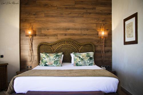 a bedroom with a large bed with two lights at Africa Jade Thalasso in Korba