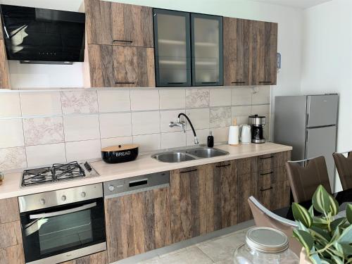 a kitchen with a sink and a stove top oven at Apartment Lupo in Vodnjan