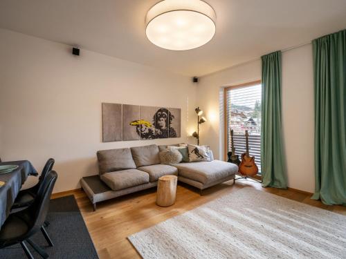 a living room with a couch and a table at Ferienwohnung Hammerwirt in Fieberbrunn