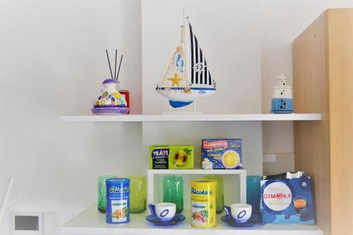 a shelf with food and other items on it at Zefiro Holiday Home in Agropoli