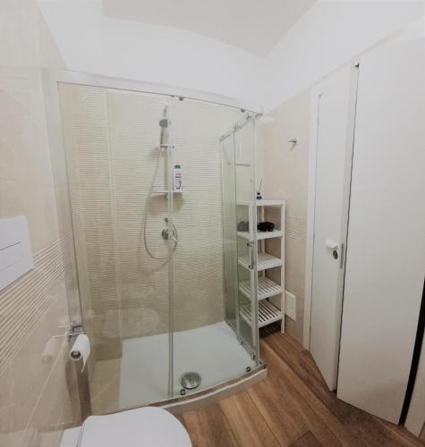 a shower with a glass door in a bathroom at Zefiro Holiday Home in Agropoli