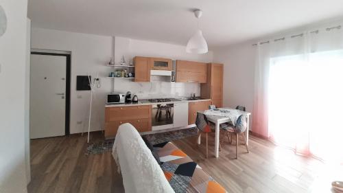 a living room with a table and a kitchen at Zefiro Holiday Home in Agropoli