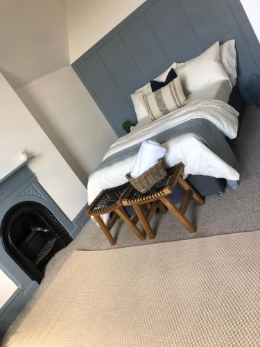 a bedroom with a bed with pillows and a table at Deluxe Huge Detached House with Parking, sleeps up to 30 people, 2m from Liverpool City Centre in Liverpool