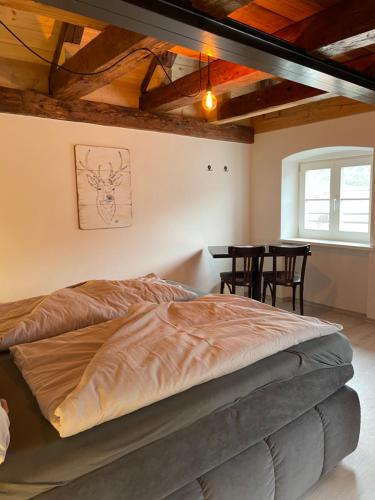 a bedroom with a bed and a table with chairs at 24-7 Apartment Passau in Passau