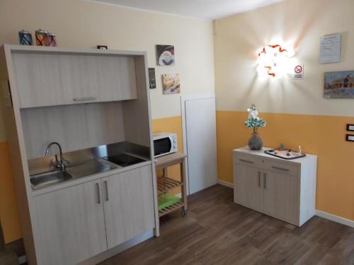 a small kitchen with a sink and a refrigerator at Venice Airport Villa Erica 1 in Campalto